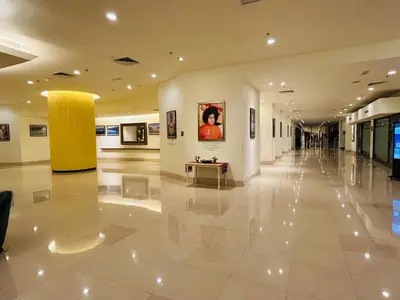 a large lobby with a painting on the wall and a table at DYNAMIC SUITES by TIMES SQUARE KL in Kuala Lumpur