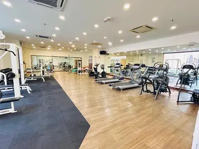 a gym with treadmills and machines in a room at DYNAMIC SUITES by TIMES SQUARE KL in Kuala Lumpur