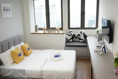 a living room with a white couch and windows at Riveria City Kuala Lumpur in Kuala Lumpur
