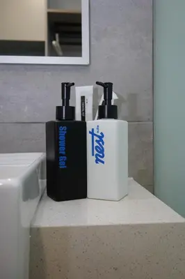 two bottles ofodorizers sitting on a counter in a bathroom at Riveria City Kuala Lumpur in Kuala Lumpur