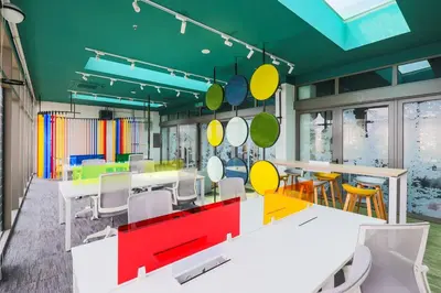 a dining room with colorful tables and chairs at Riveria City Kuala Lumpur in Kuala Lumpur