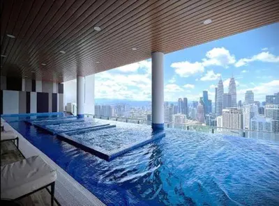 a large swimming pool with a view of a city at Dreamy Destiny Suites At Infinitum KLCC Pool View in Kuala Lumpur
