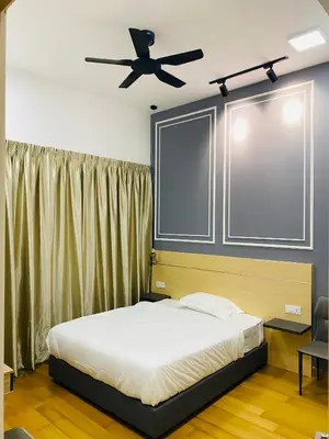 a bedroom with a bed with a ceiling fan at Dreamy Destiny Suites At Infinitum KLCC Pool View in Kuala Lumpur