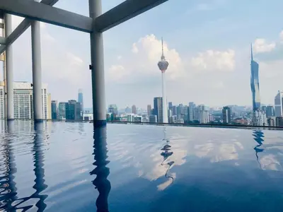 a swimming pool with a view of the city at Dreamy Destiny Suites At Infinitum KLCC Pool View in Kuala Lumpur