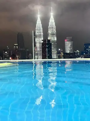 a large swimming pool with a view of the city at Dreamy Destiny Suites At Infinitum KLCC Pool View in Kuala Lumpur