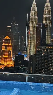 a view of a city skyline at night at Dreamy Destiny Suites At Infinitum KLCC Pool View in Kuala Lumpur