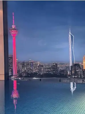a large swimming pool with a view of a city at Dreamy Destiny Suites At Infinitum KLCC Pool View in Kuala Lumpur