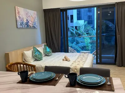a bedroom with a bed and a table with plates on it at MCity Studio With Balcony, Near KLCC, Gleneagles Hosp, Ampang Puteri Hosp in Kuala Lumpur