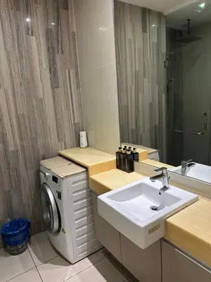 a bathroom with a sink and a washing machine at MCity Studio With Balcony, Near KLCC, Gleneagles Hosp, Ampang Puteri Hosp in Kuala Lumpur