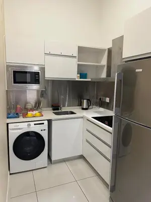 a kitchen with a washing machine and a microwave at MCity Jalan Ampang 5mins KLCC, Gleneagles Hospital in Kuala Lumpur