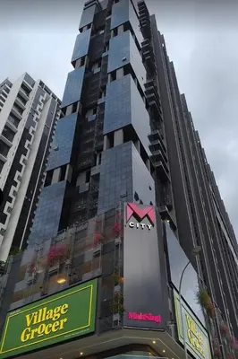 a tall building with a sign in front of it at MCity Jalan Ampang 5mins KLCC, Gleneagles Hospital in Kuala Lumpur