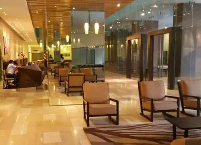 a lobby with chairs and tables in a building at MCity Jalan Ampang 5mins KLCC, Gleneagles Hospital in Kuala Lumpur