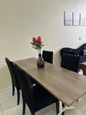 a vase with flowers sitting on a wooden table at MCity Jalan Ampang 5mins KLCC, Gleneagles Hospital in Kuala Lumpur