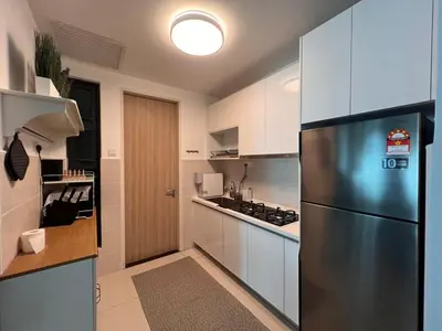 a kitchen with a stainless steel refrigerator and white cabinets at Legasi Kg Bharu with KLCC view near LRT Station in Kuala Lumpur