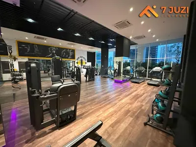 a gym with treadmills and machines in a building at Luxury and Cozy Suite KL and 118 TOWER View Netflix 1080HD in Kuala Lumpur