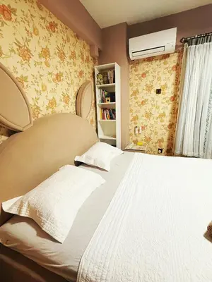 a bedroom with a large bed and a book shelf at Bintang Home in Kuala Lumpur