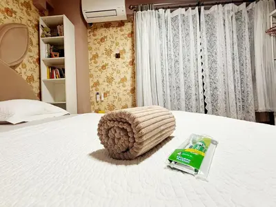 a bed with a bottle of sprite on it at Bintang Home in Kuala Lumpur