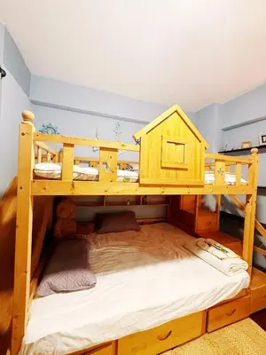 a wooden bunk bed with a play house on it at Bintang Home in Kuala Lumpur