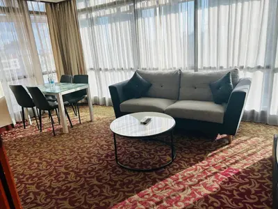 a living room with a couch and a table at TIMES SQUARE SERVICE SUITE at KUALALUMPUR in Kuala Lumpur