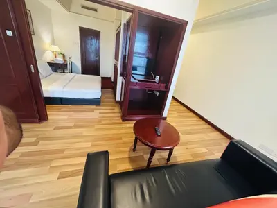 a room with a bed and a couch and a table at TIMES SQUARE SERVICE SUITE at KUALALUMPUR in Kuala Lumpur