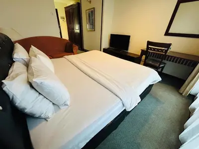 a bedroom with a bed with white sheets and pillows at TIMES SQUARE SERVICE SUITE at KUALALUMPUR in Kuala Lumpur