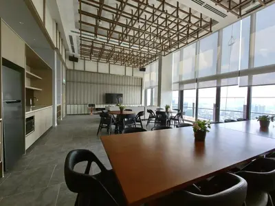 an office with tables and chairs and windows at TRX Agile Bukit Bintang 2 Bedroom Deluxe Suites in Kuala Lumpur