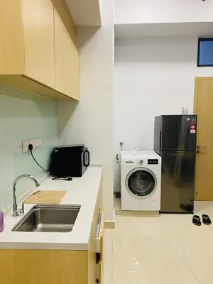 a kitchen with a refrigerator and a washing machine at Dreamy Destiny Suites At KLCC Swimming Pool View in Kuala Lumpur
