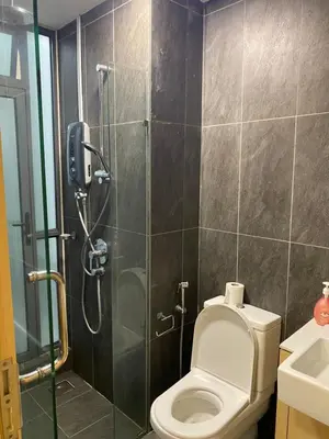 a bathroom with a shower with a toilet and a sink at Dreamy Destiny Suites At KLCC Swimming Pool View in Kuala Lumpur