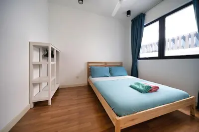 a bedroom with a bed with blue sheets and a window at Velocity mall & Mytown ikea with Stunning KLCC view in Kuala Lumpur