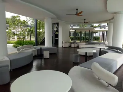 a lobby with couches and tables and chairs at Velocity mall & Mytown ikea with Stunning KLCC view in Kuala Lumpur