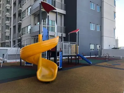 a playground with a slide in front of a building at Modern and Comforts RC Residence Fully Aircond in Kuala Lumpur