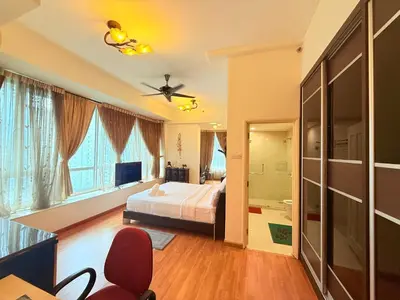 a bedroom with a bed and a ceiling fan at Park view Apartment near klcc in Kuala Lumpur
