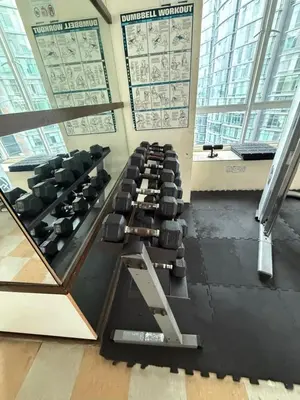 a gym with rows of chairs in a room with windows at Park view Apartment near klcc in Kuala Lumpur