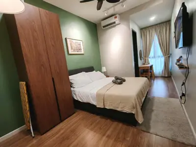 a bedroom with a bed and a green wall at Studio Sunway Velocity 2 Link Bridge to Mall in Kuala Lumpur
