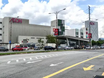 an empty street with cars parked in front of a building at Studio Sunway Velocity 2 Link Bridge to Mall in Kuala Lumpur