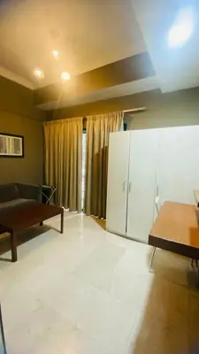 a living room with a couch and a table at Studio apartment in Kuala Lumpur