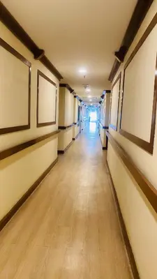 an empty hallway in a building with paintings on the walls at Studio apartment in Kuala Lumpur
