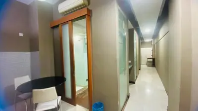 a hallway with a table and chairs in a room at Studio apartment in Kuala Lumpur