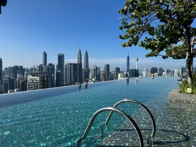 a swimming pool with a city skyline in the background at Expressionz KLCC By Laze Home in Kuala Lumpur