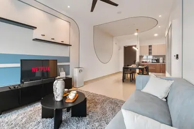 a living room with a couch and a tv at Sydney Sunset 3BR M Vertica Near MRT by RumaBnB in Kuala Lumpur