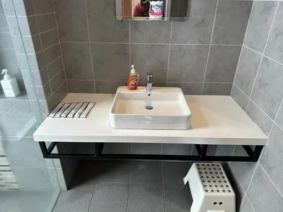 a bathroom with a white sink and a shower at Parkview Family Suite klcc with views in Kuala Lumpur