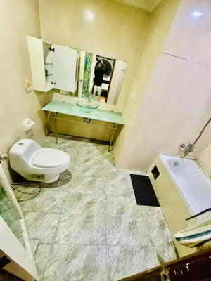 a bathroom with a toilet and a sink and a mirror at Parkview Family Suite klcc with views in Kuala Lumpur