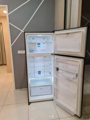 an empty refrigerator with its door open in a kitchen at Parkview Family Suite klcc with views in Kuala Lumpur
