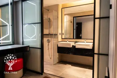a bathroom with two sinks and a shower at The Oak Room At M101 in Kuala Lumpur