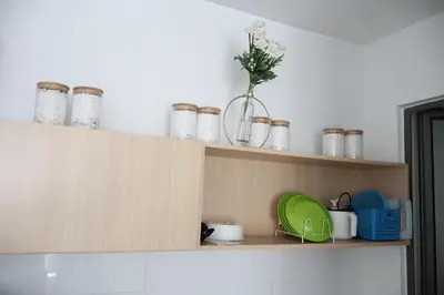a kitchen shelf with jars and a vase on it at Cozy kenwingston platz kl 2-5pax 2BR&2BR Klcc view free paikin wifi1907 in Kuala Lumpur