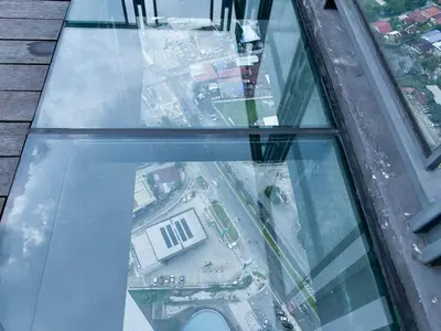 an aerial view of a city from the glass floor of a skyscraper at Cozy kenwingston platz kl 2-5pax 2BR&2BR Klcc view free paikin wifi1907 in Kuala Lumpur