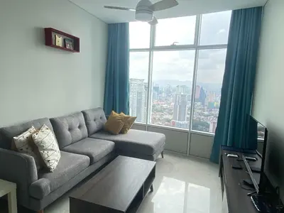 a living room with a couch and a large window at Sky Suites Luxury unit with KLCC view in Kuala Lumpur