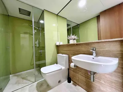 a bathroom with a toilet and a sink and a shower at Sky Suites Luxury unit with KLCC view in Kuala Lumpur