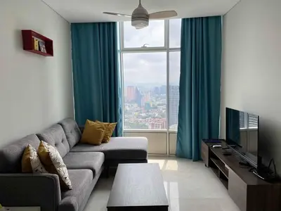 a living room with a couch and a large window at Sky Suites Luxury unit with KLCC view in Kuala Lumpur