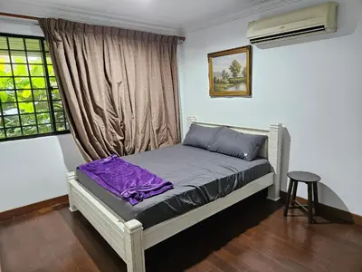 a bed in a room with a window and a table at X'Apartelle near Pusat Bandar Damansara MRT in Kuala Lumpur